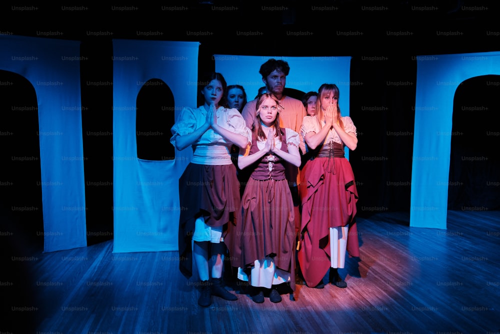 a group of people standing on top of a wooden floor