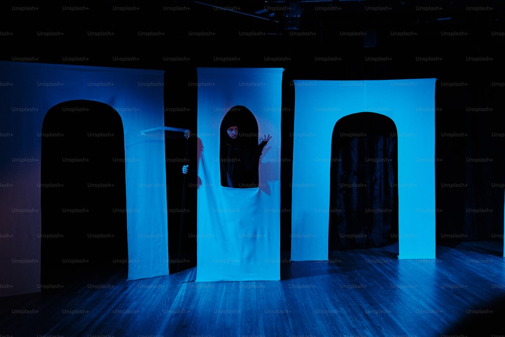 a woman standing in a doorway in a dark room