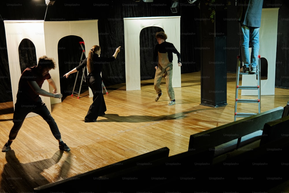 a group of people standing on top of a wooden floor