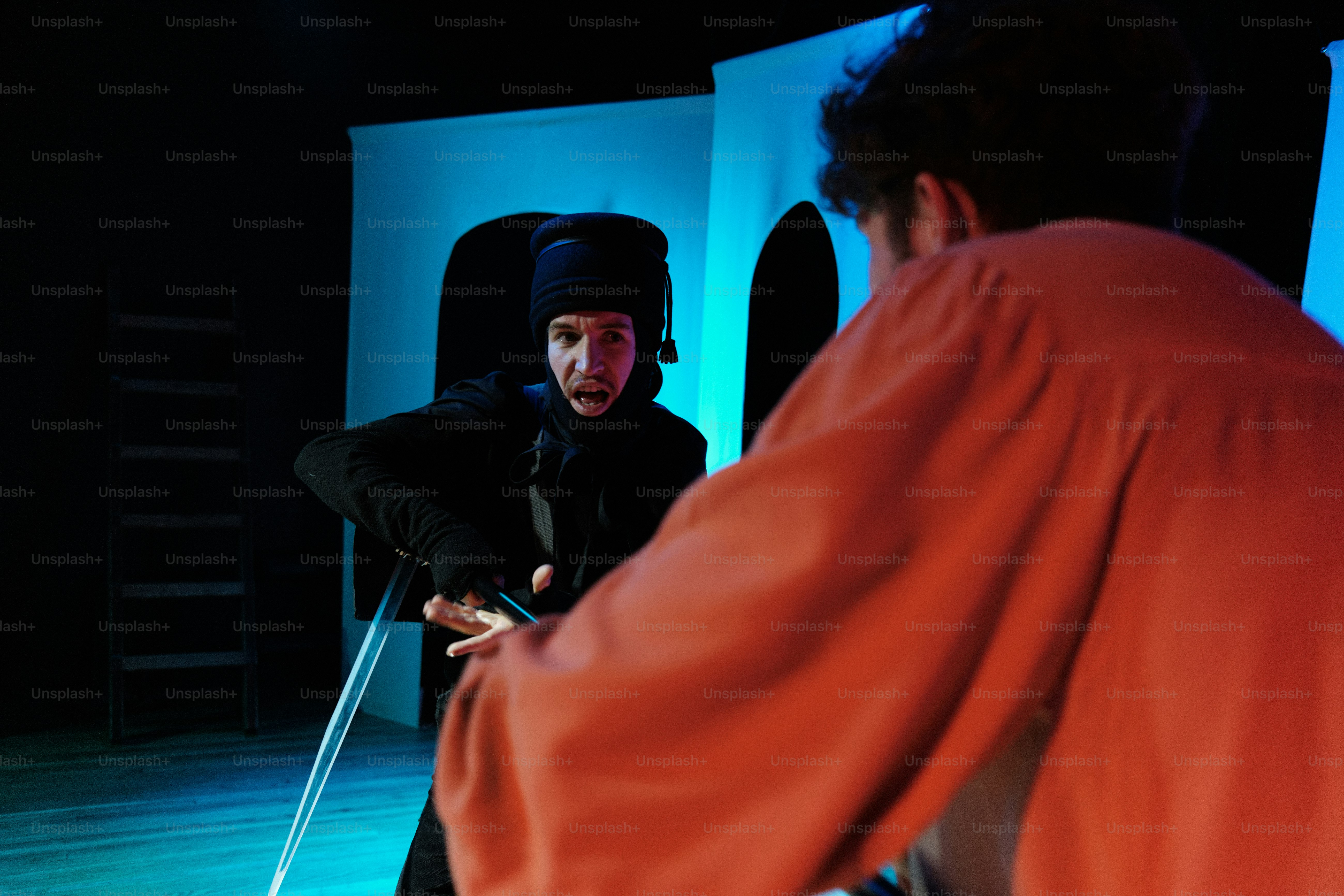 a man standing next to another man on a stage