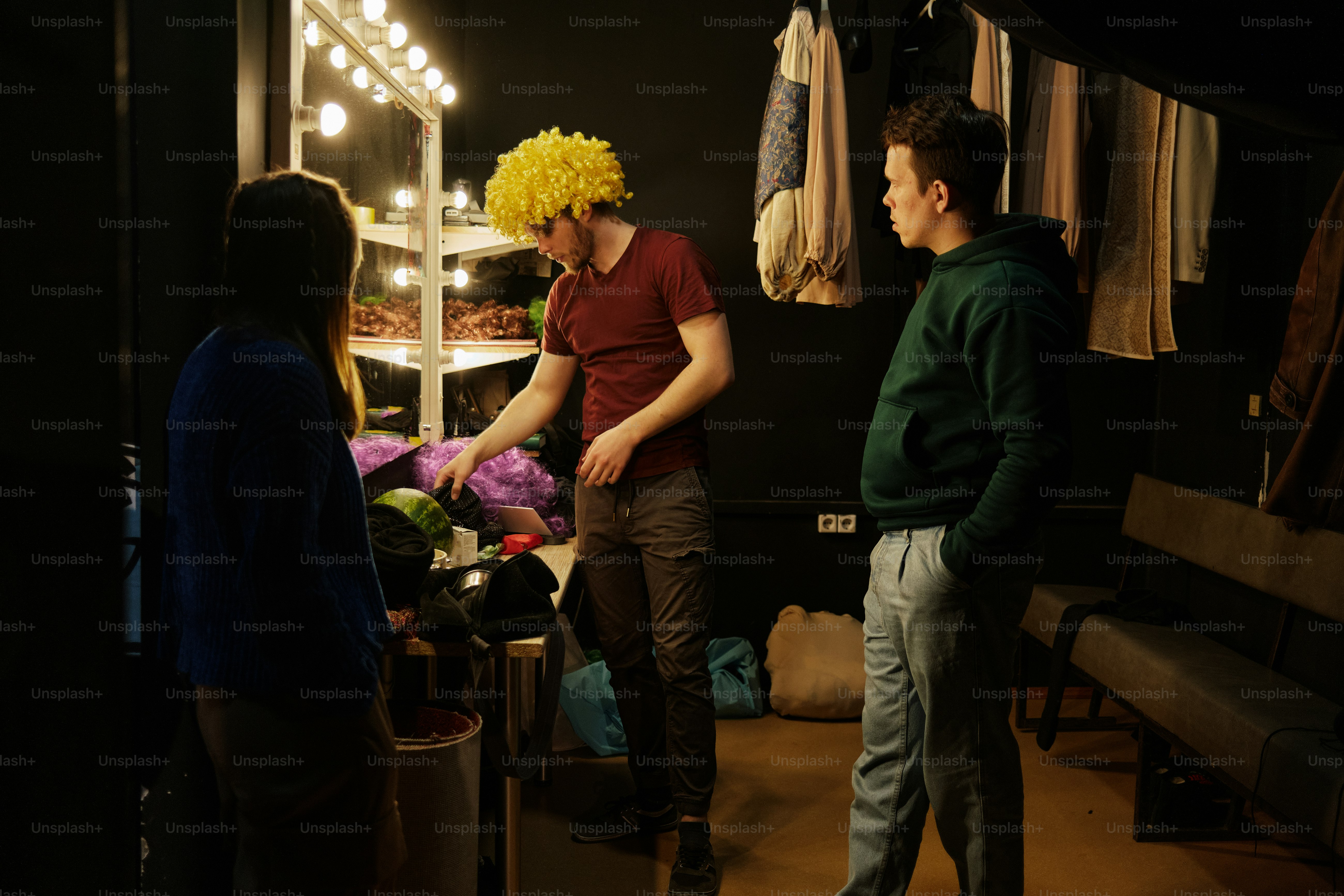 a man with a clown wig standing next to a woman