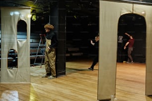 a group of people standing on top of a wooden floor