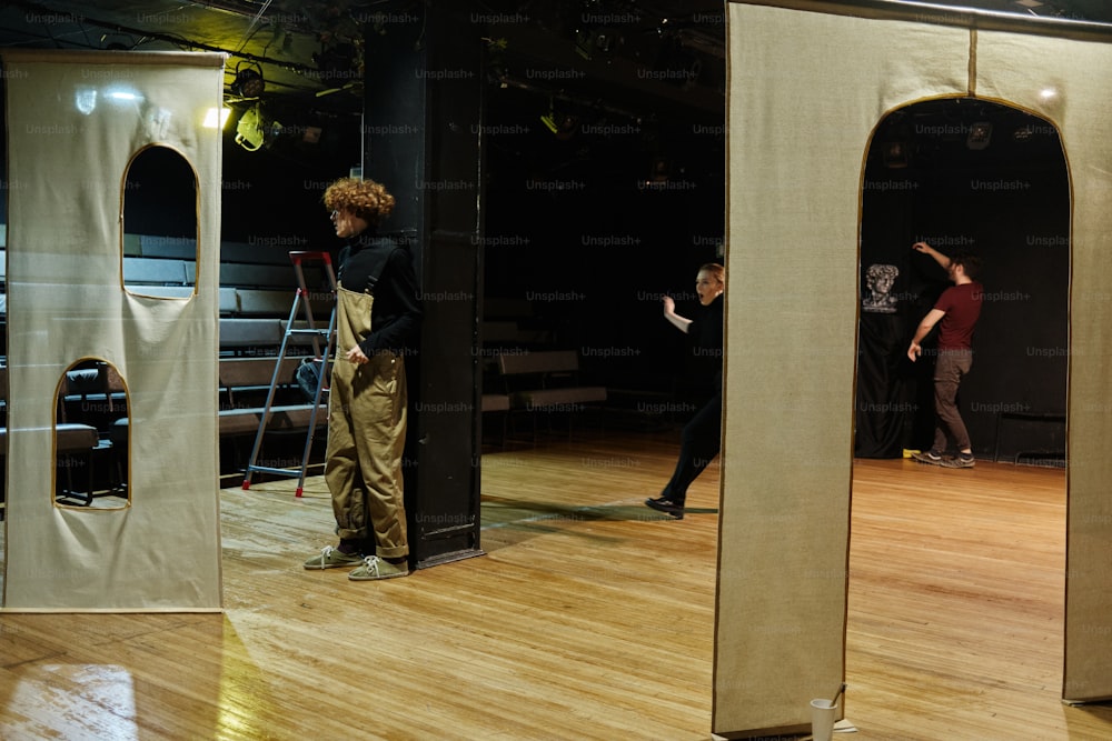 a group of people standing on top of a wooden floor