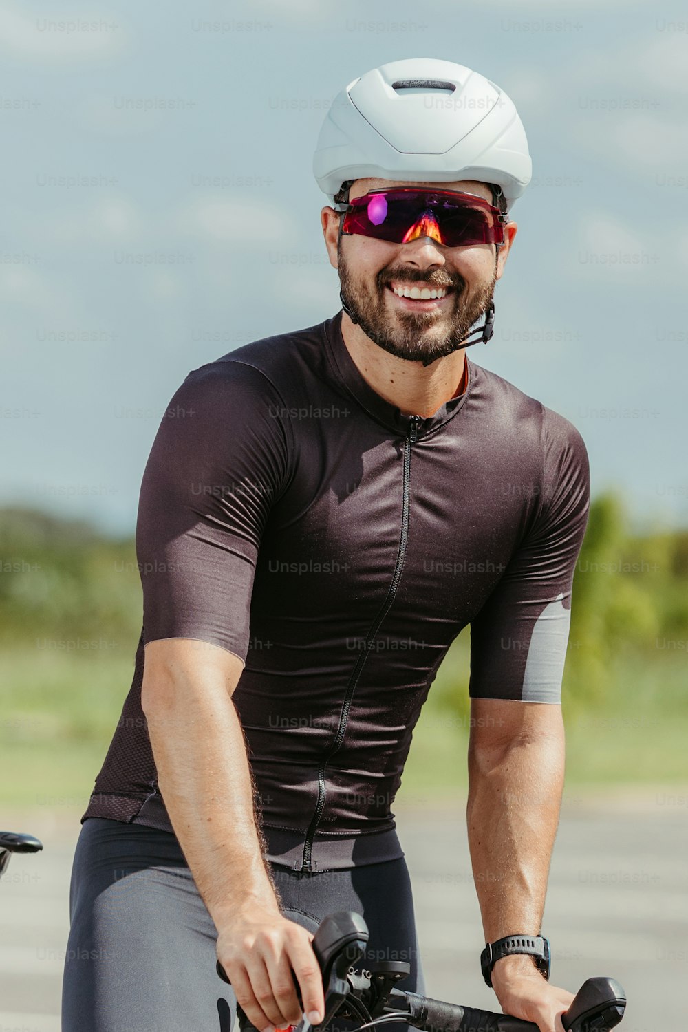 a man wearing a helmet and sunglasses riding a bike