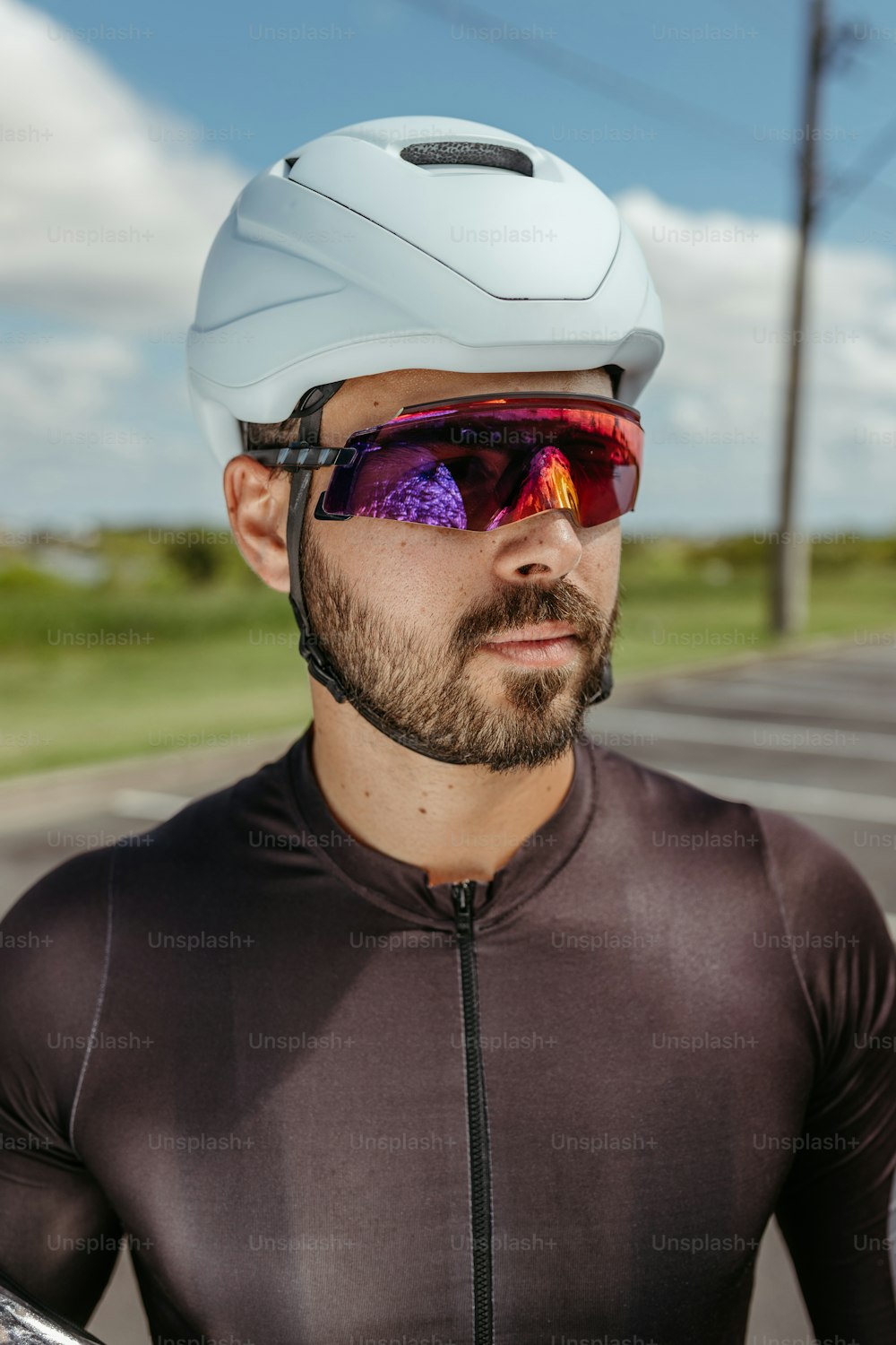 a man wearing a helmet and sunglasses while riding a bike