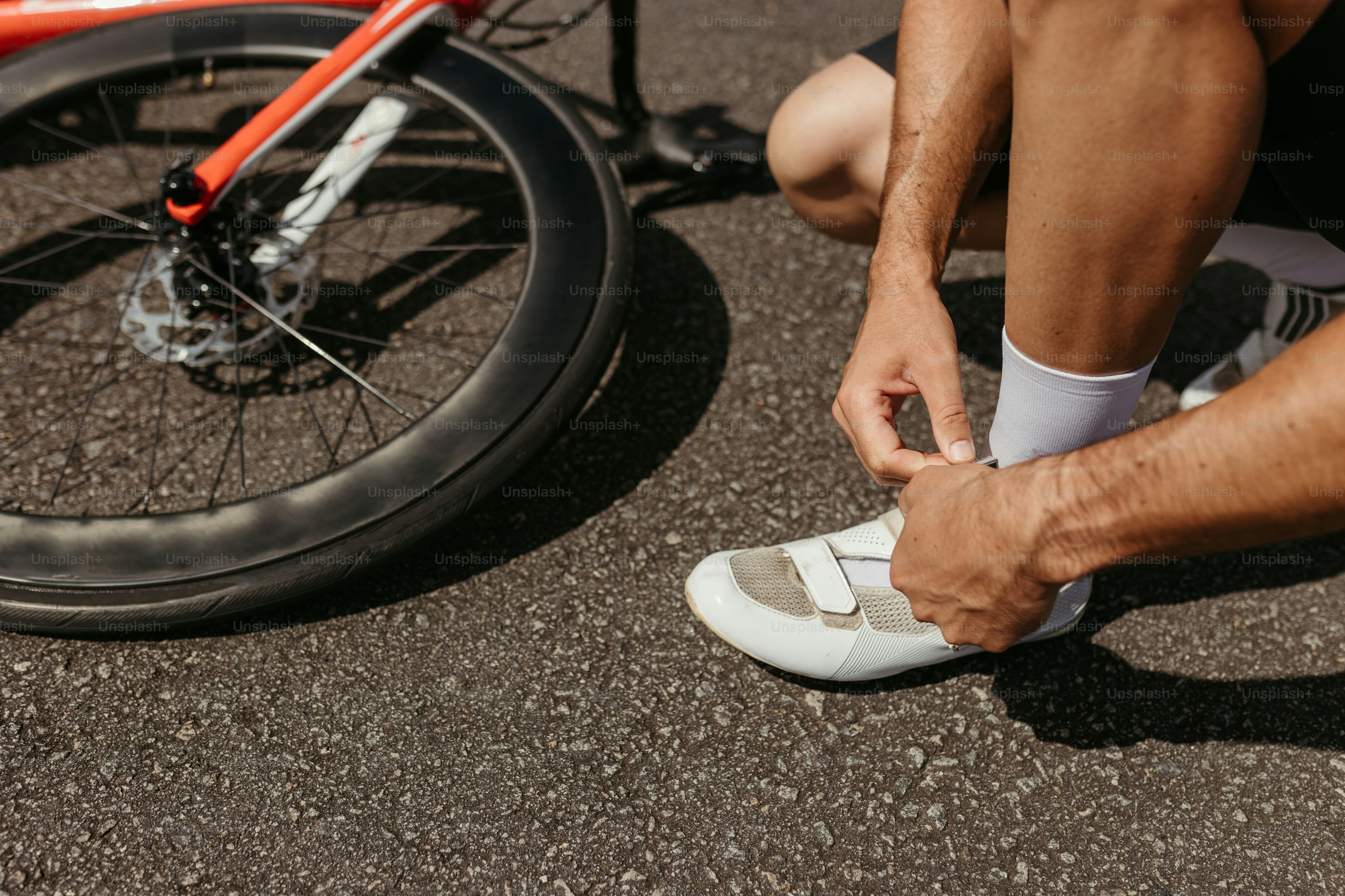 a close up of a person tying a pair of shoes