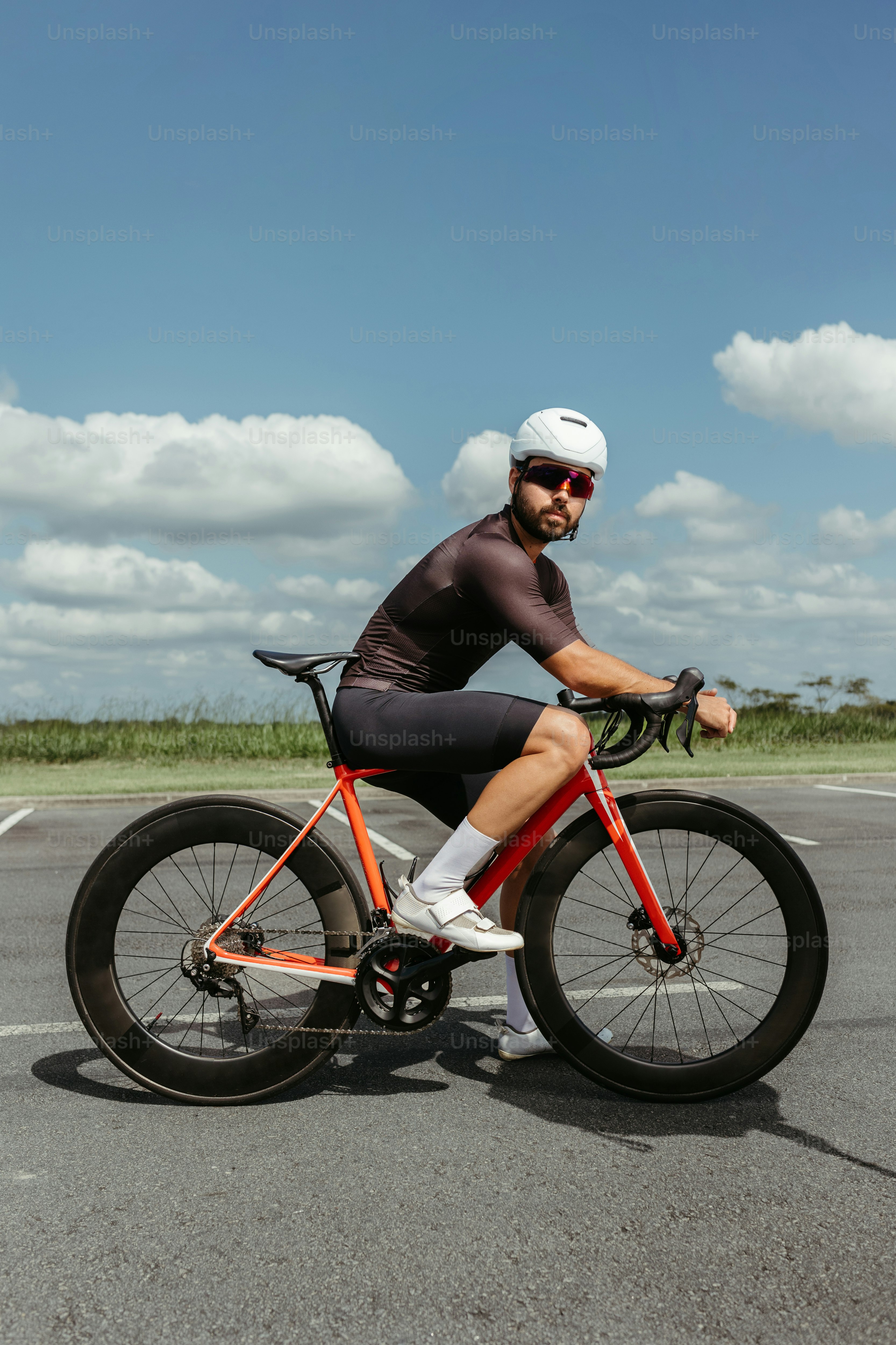 a man riding a bike on top of a parking lot