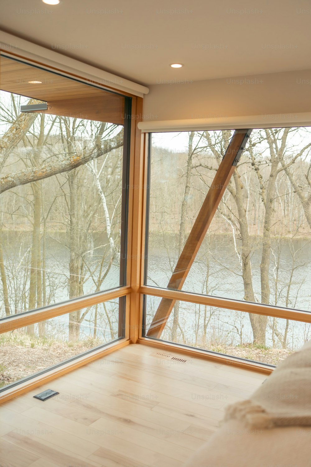 a bedroom with a large window overlooking a lake