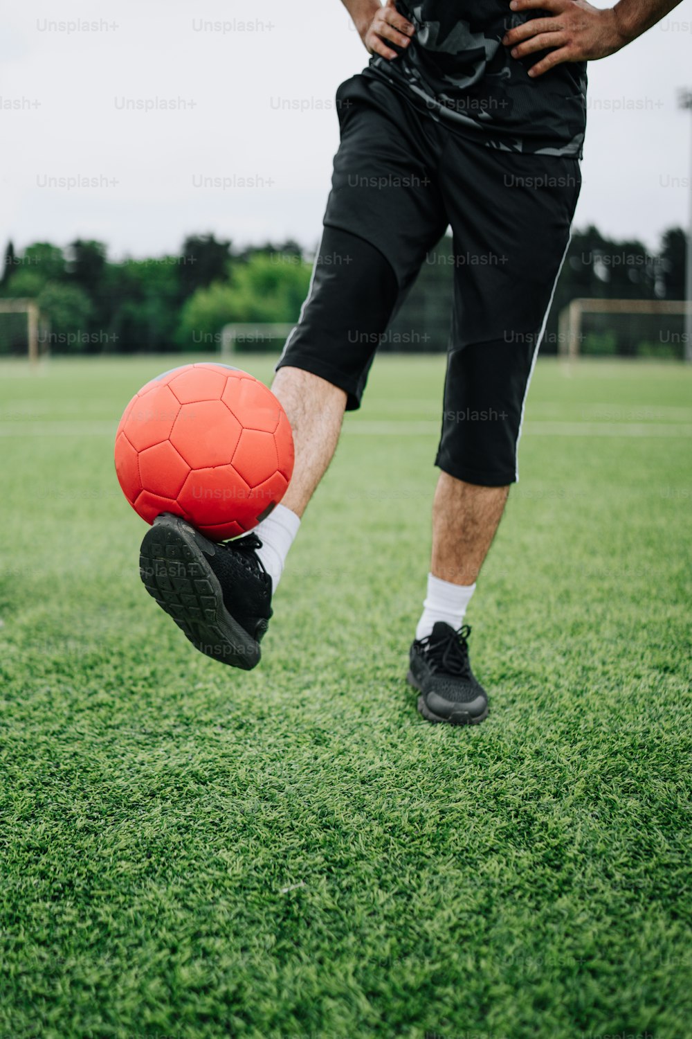 a man kicking a soccer ball on a field
