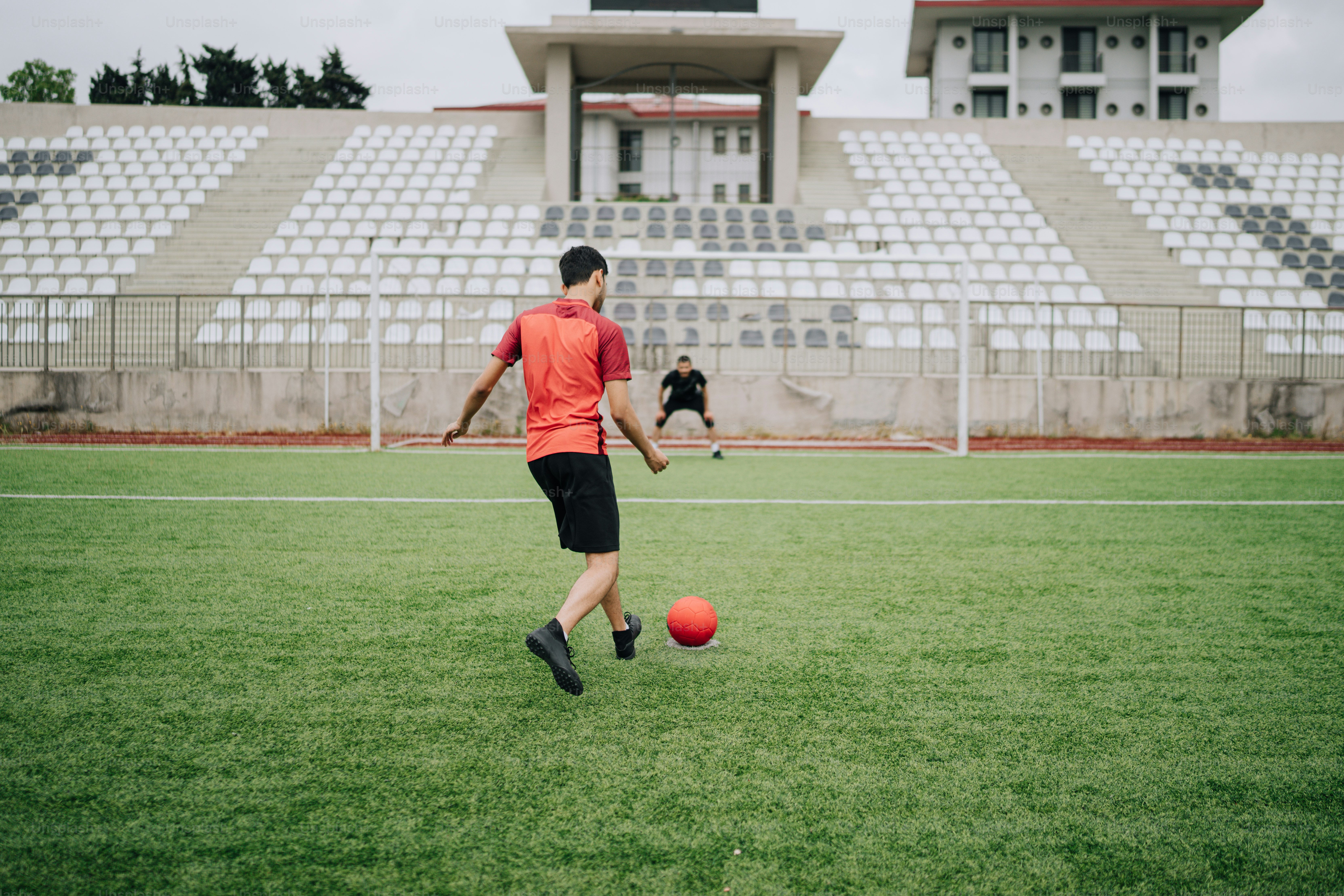 a man kicking a soccer ball on a field