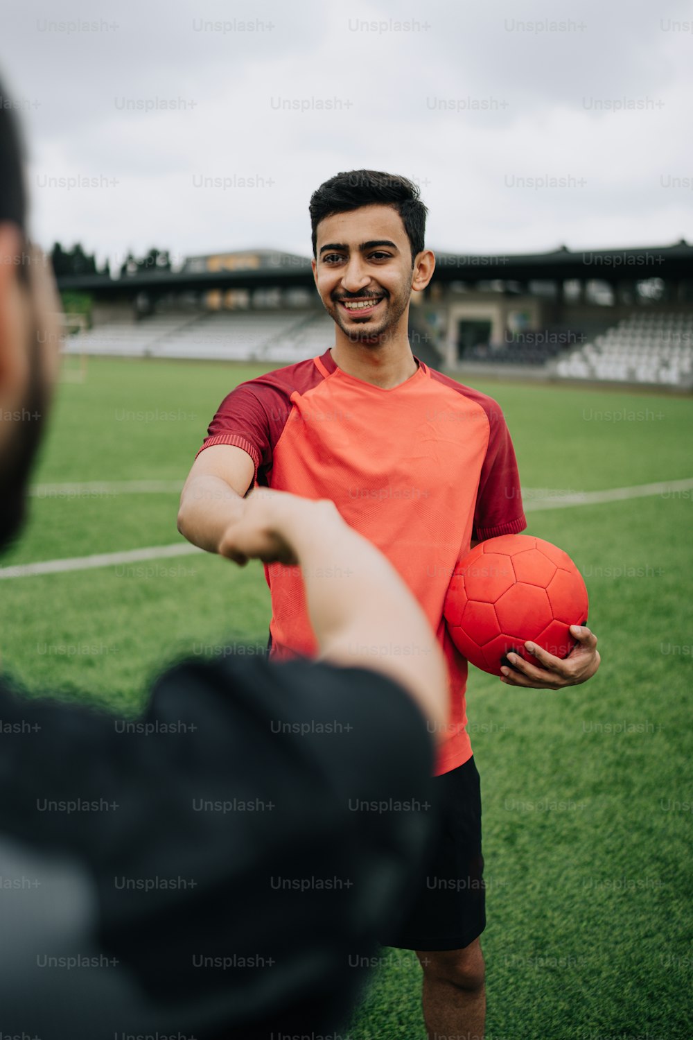 a man holding a soccer ball on a field