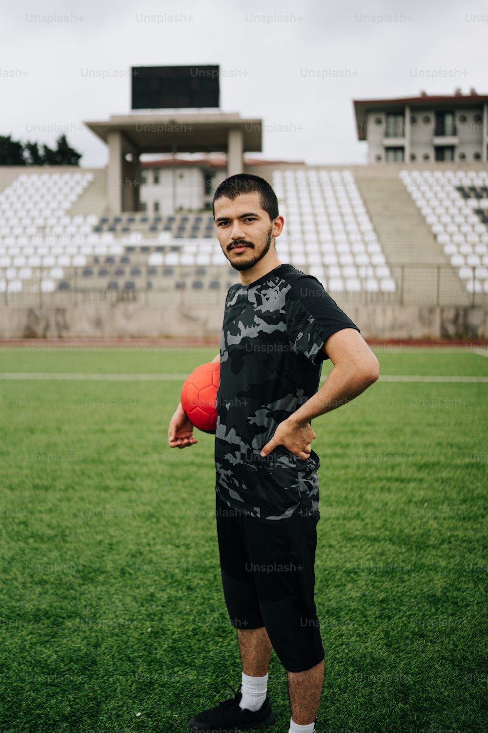 a man standing on a field holding a ball