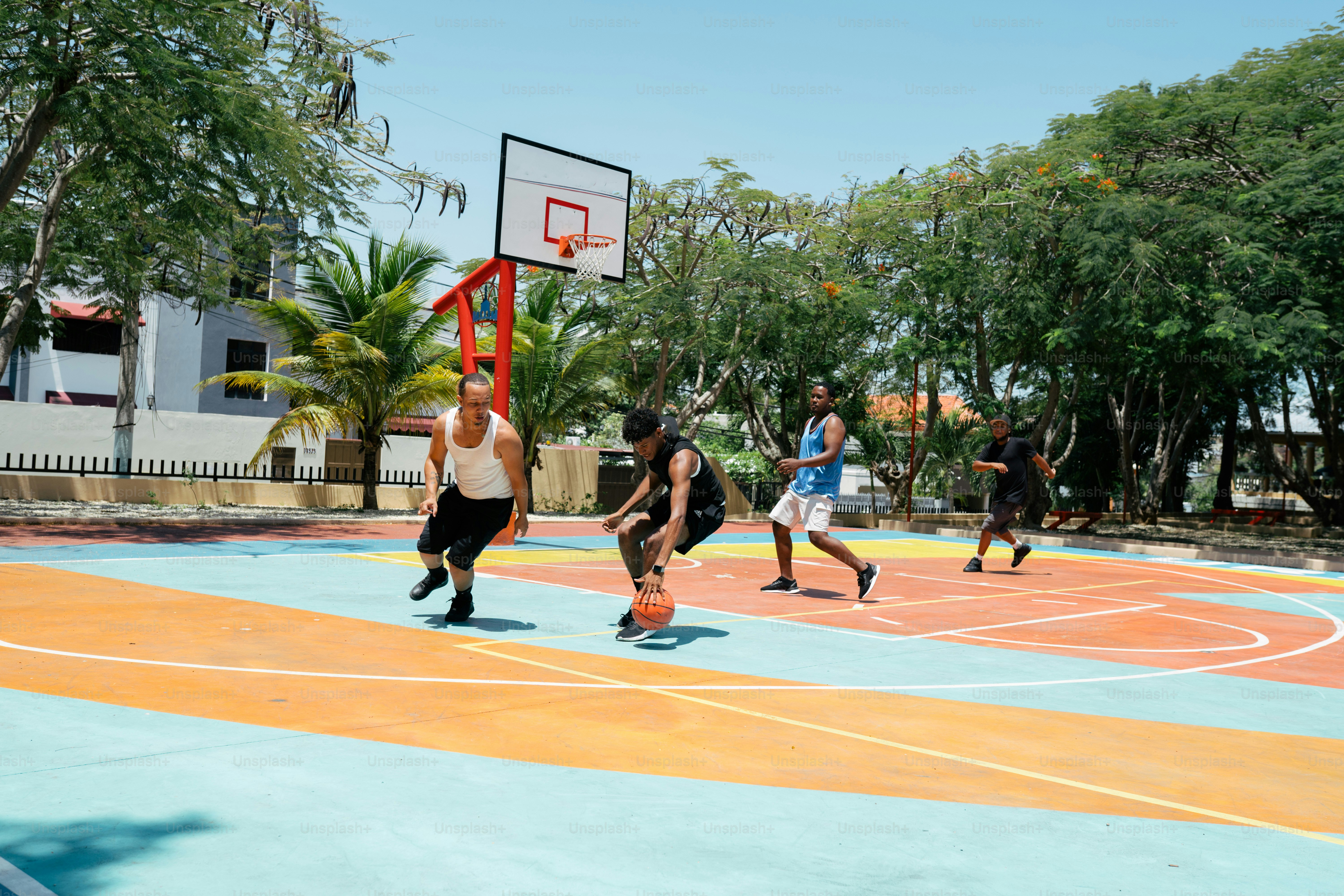 a group of young men playing a game of basketball