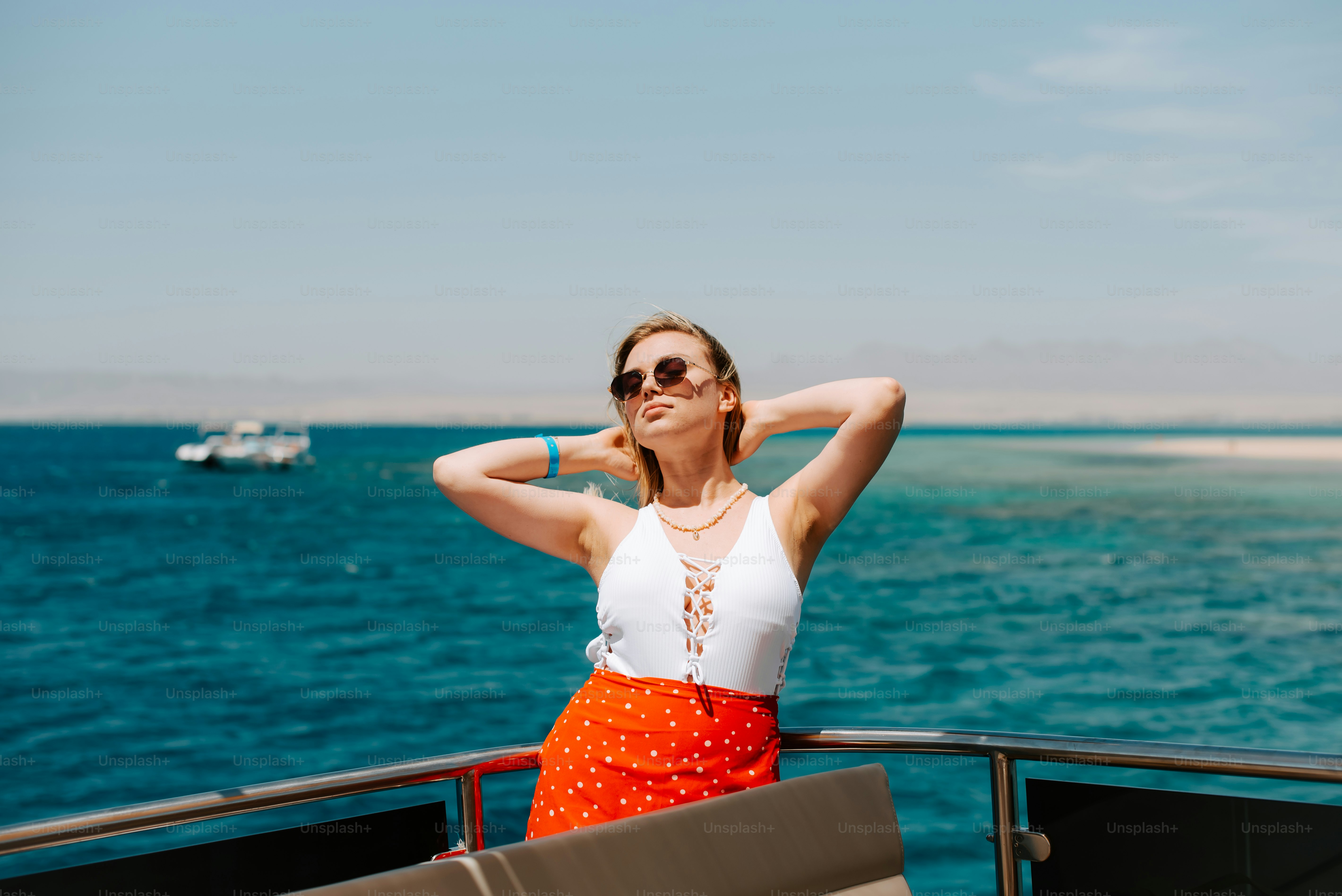A woman standing on a boat looking out at the ocean photo – Travel ...