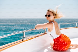 a woman sitting on the edge of a boat