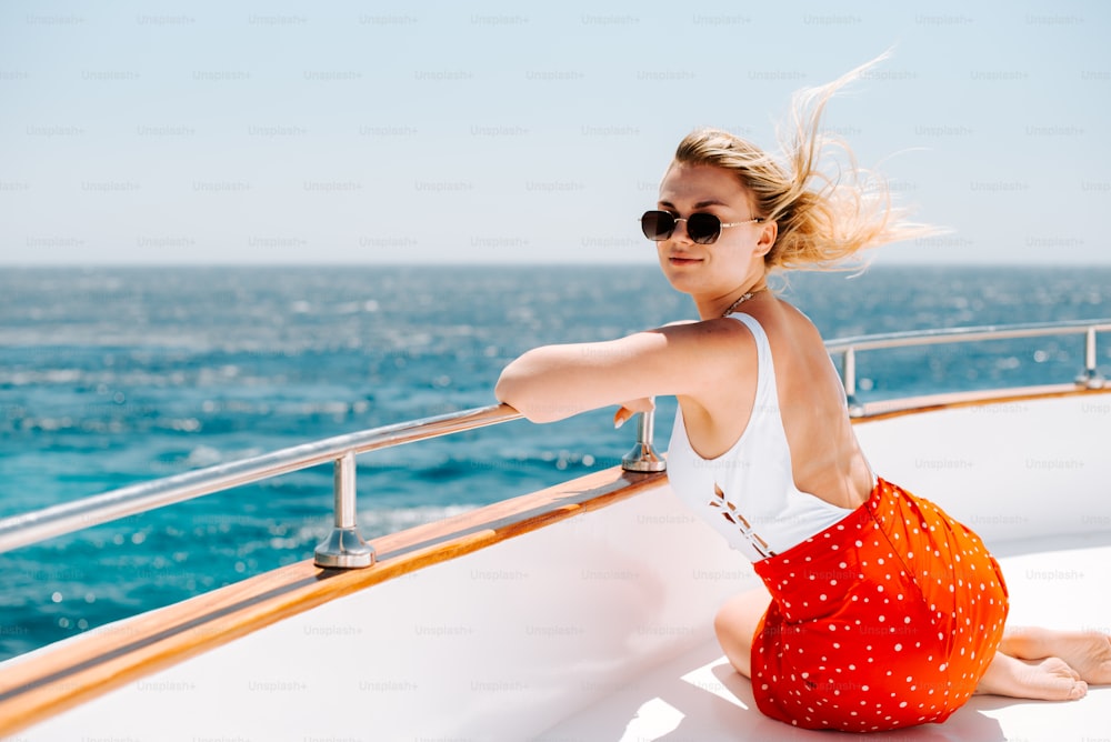 a woman sitting on the edge of a boat