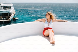 a woman sitting on the edge of a boat