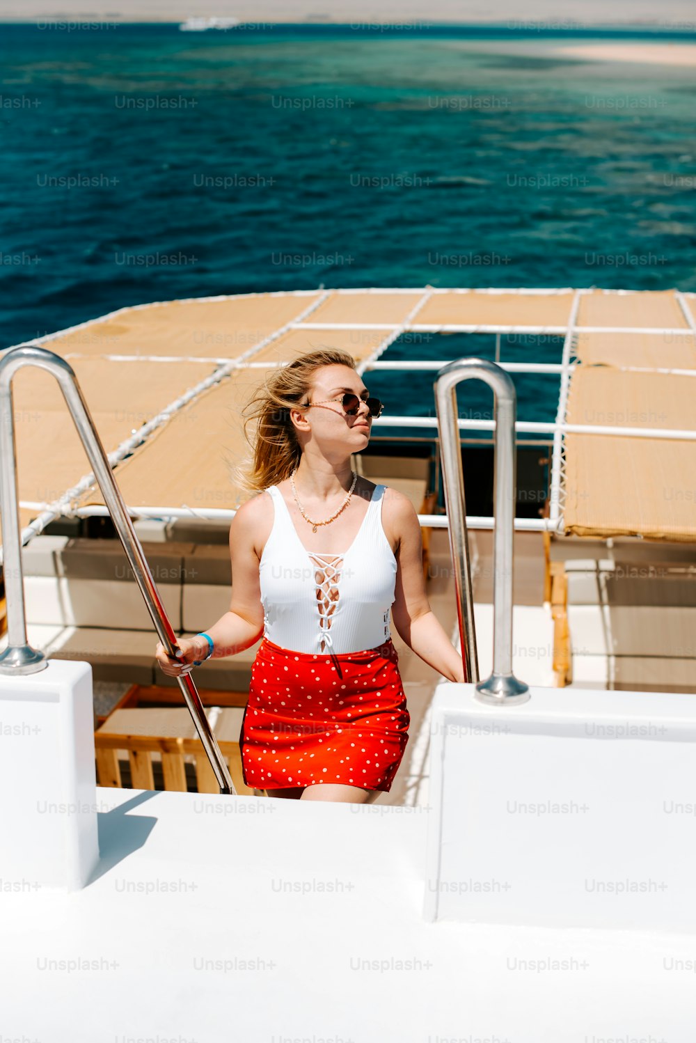 a woman in a red skirt on a boat