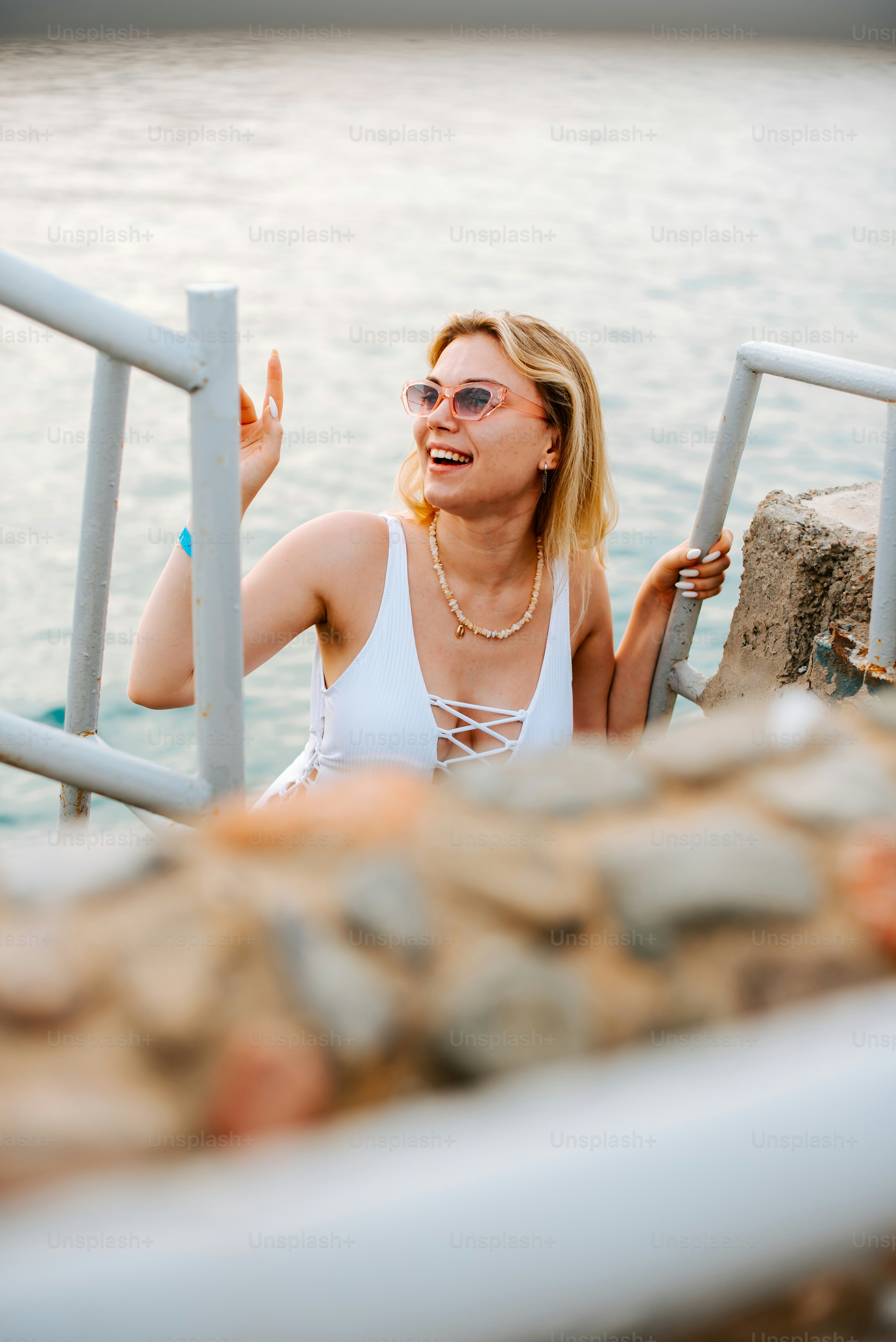 A woman sitting on a boat in the water photo – Portrait Image on Unsplash