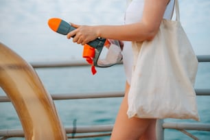 a woman holding a blow dryer on a boat