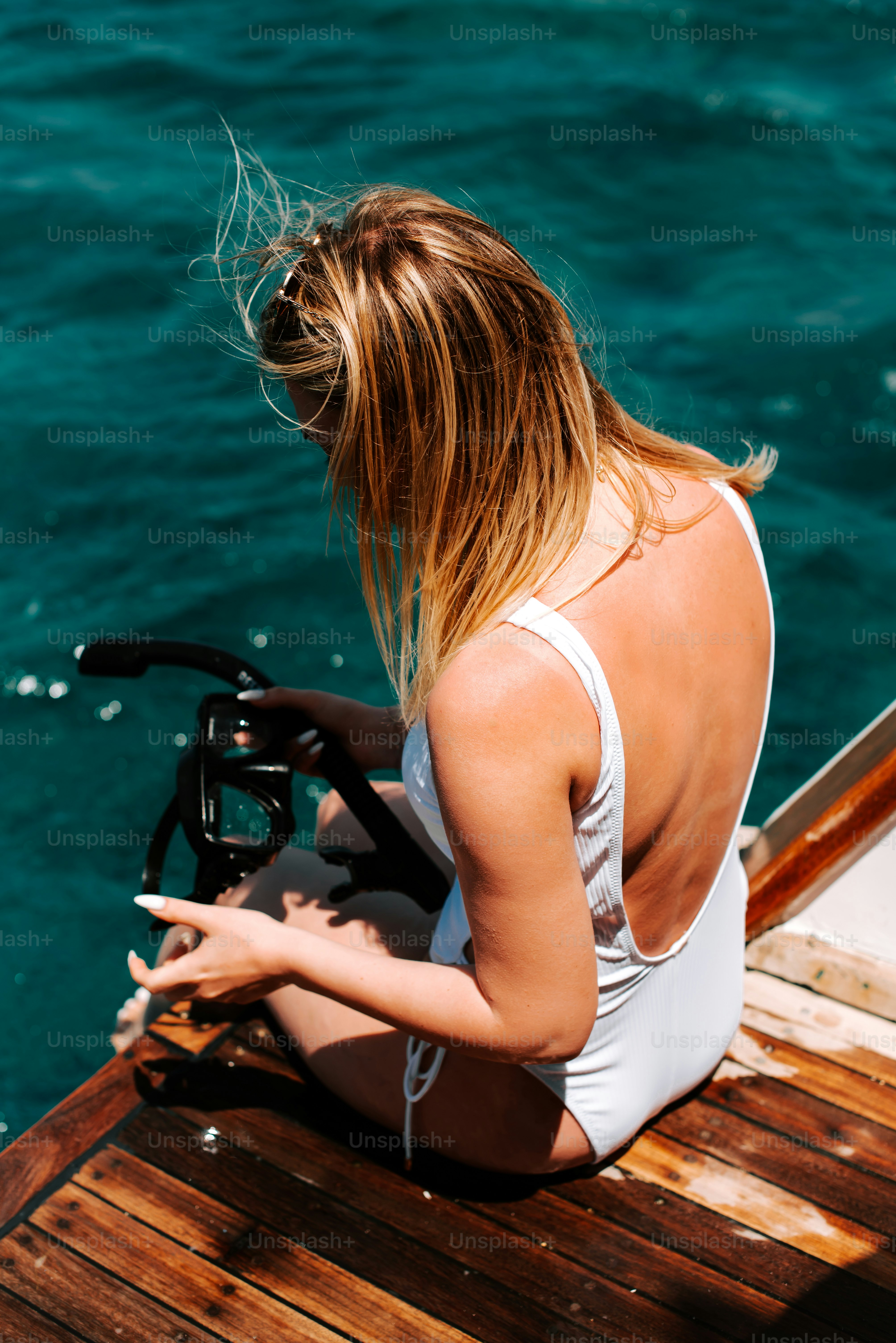 a woman sitting on a boat in the water