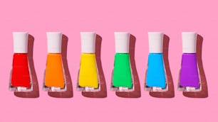 a row of different colored bottles of liquid