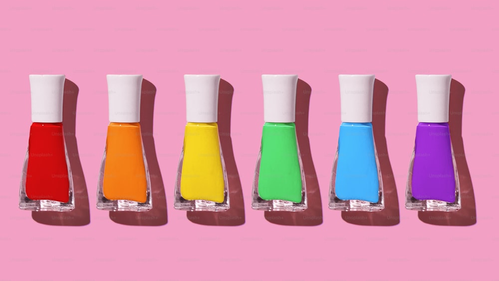 a row of different colored bottles of liquid