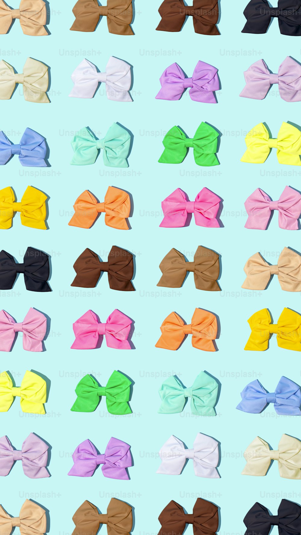 a bunch of different colored bows on a blue background