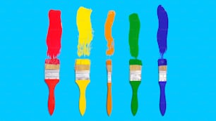 a row of paintbrushes with different colors of paint