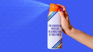 a person spraying a spray of water on a blue background