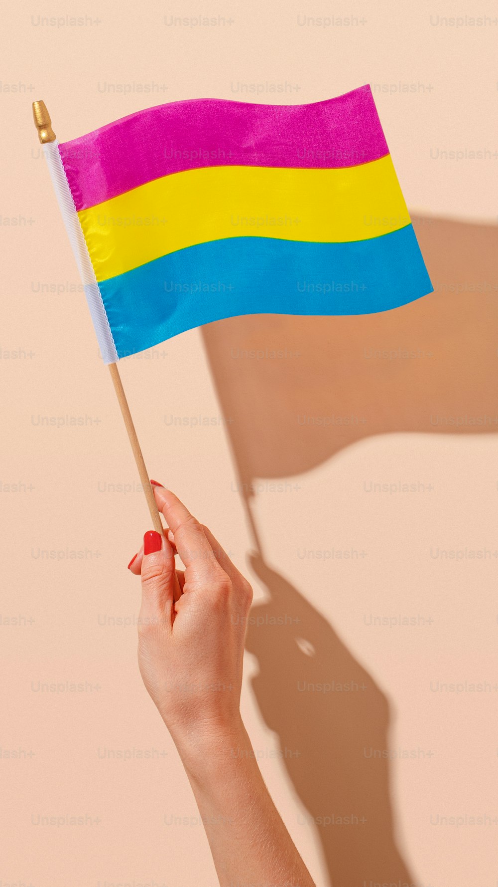 a woman holding a rainbow flag in her hand