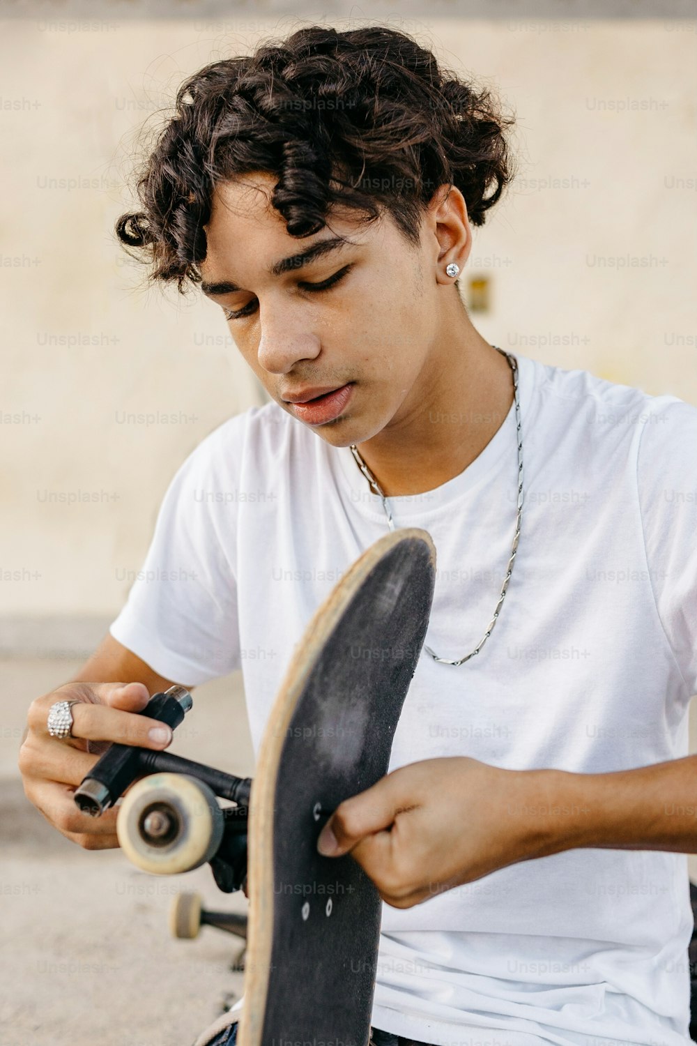 a young man holding a skateboard in his hands