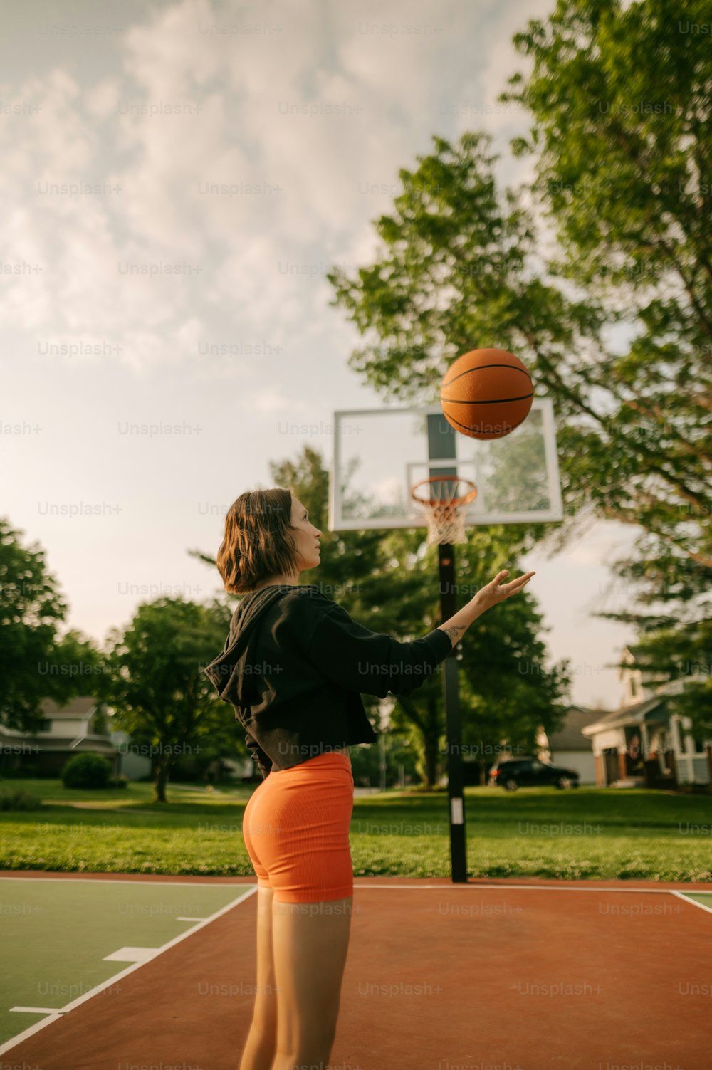a woman is playing basketball on a court