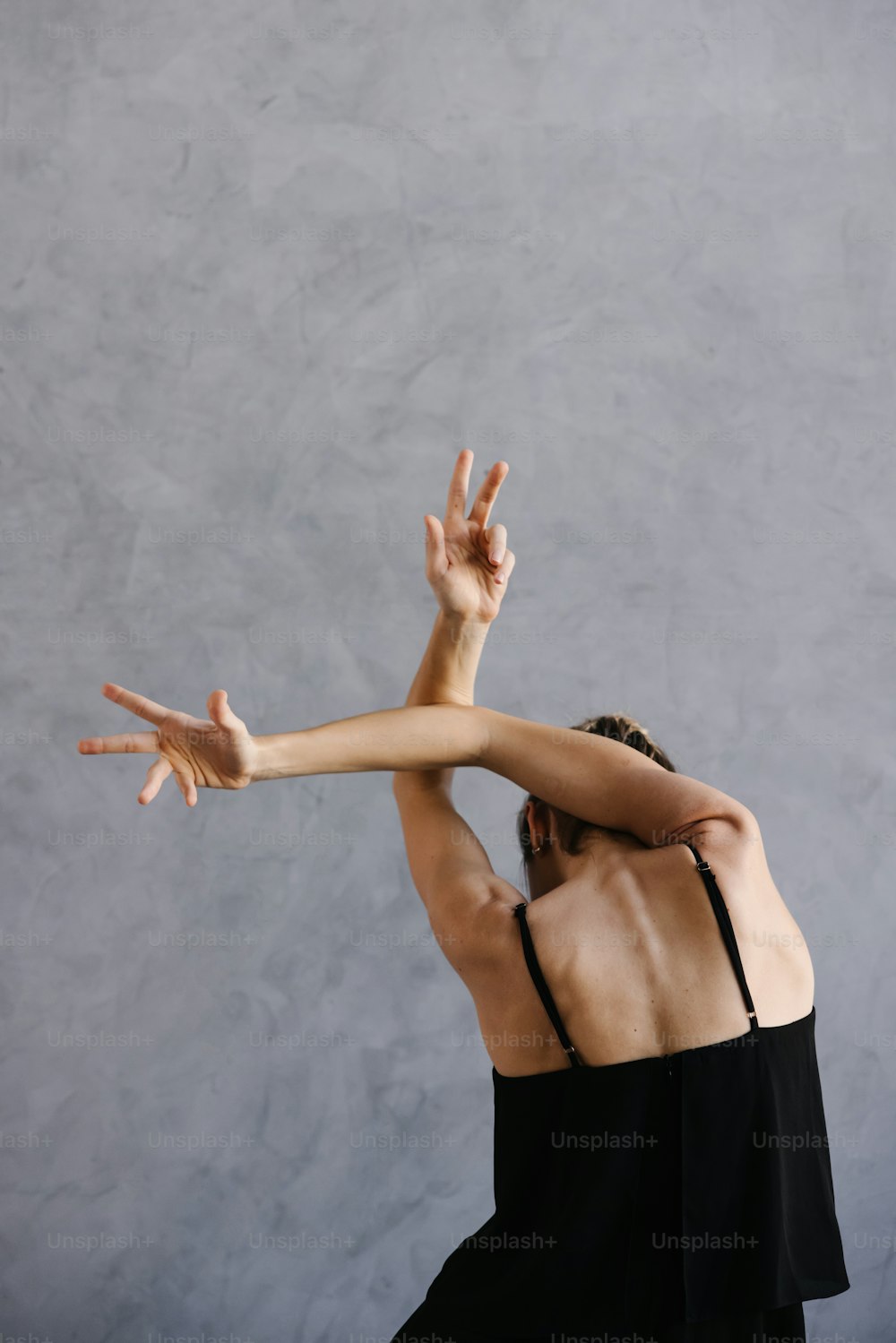 a man is doing a handstand on a gray background