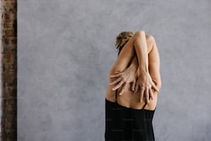 a woman with her hands on her back