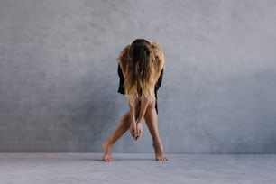 a woman bending over with her legs crossed