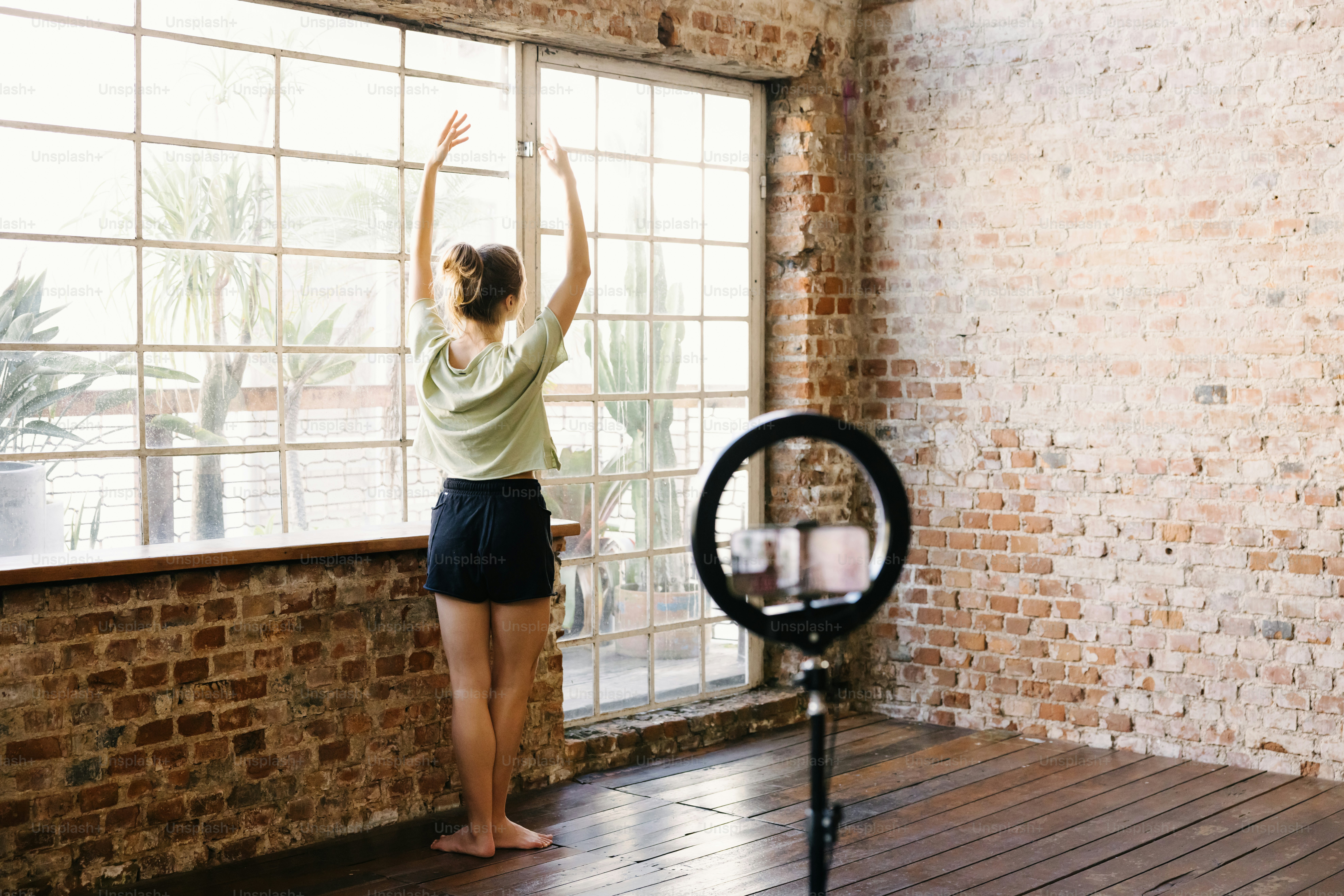 a woman standing in front of a window in a room