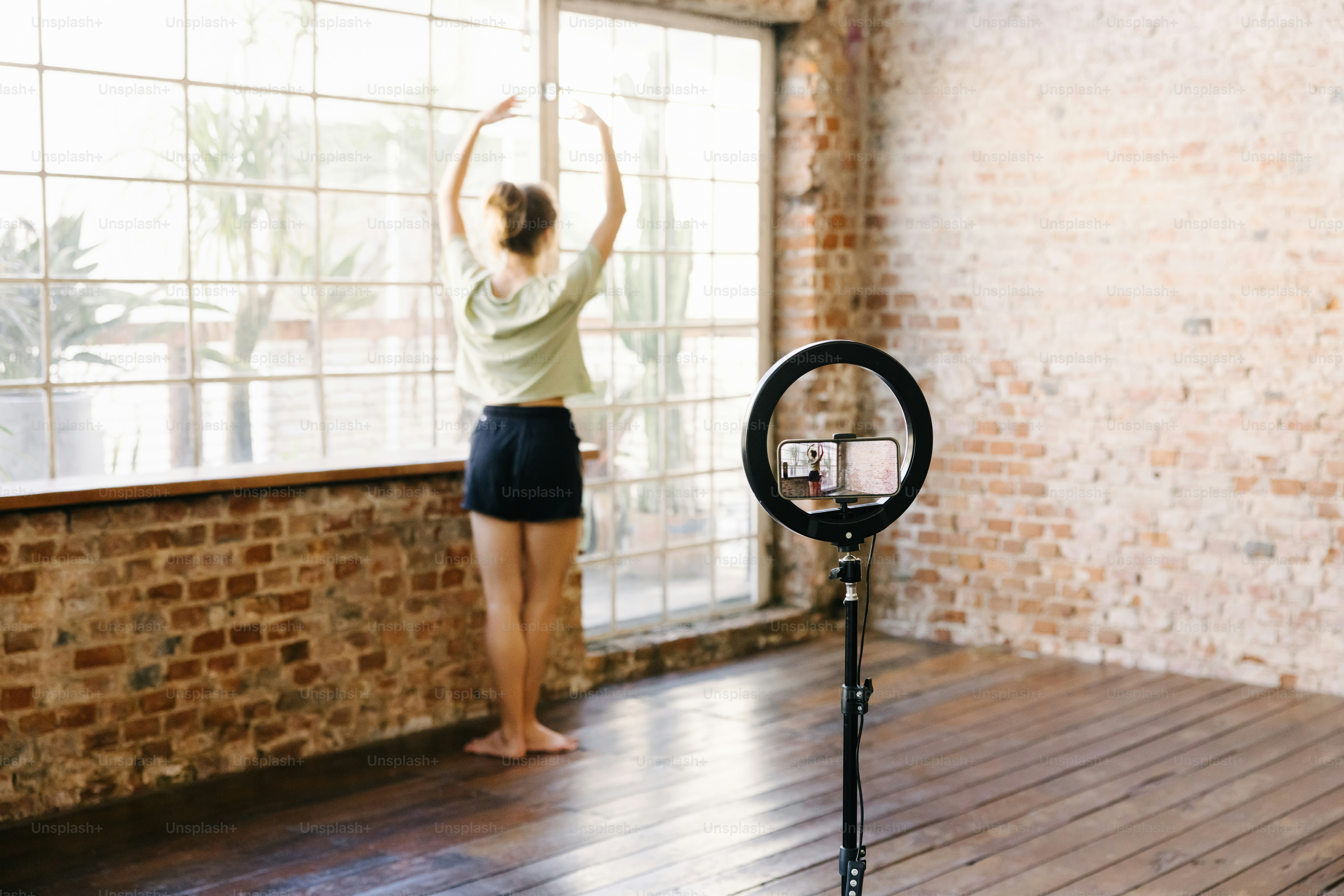 a woman standing in front of a window in a room