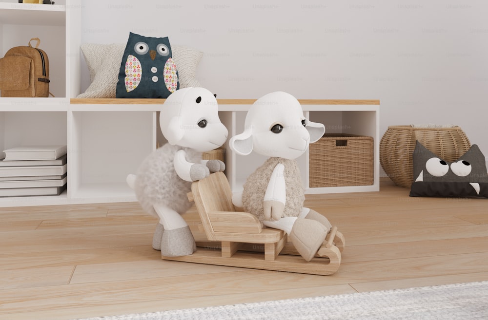 a couple of stuffed sheep sitting on top of a wooden sleigh