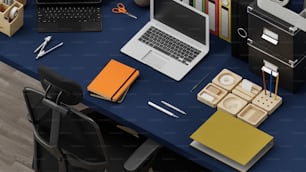 a desk with a laptop, keyboard, mouse and other office supplies