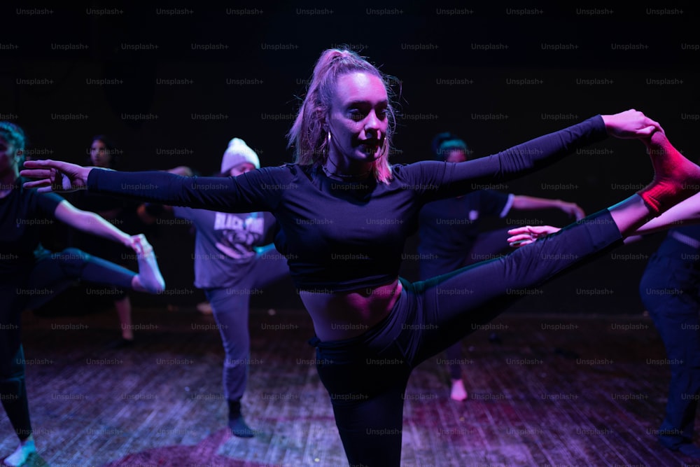 a group of people on a stage performing a dance