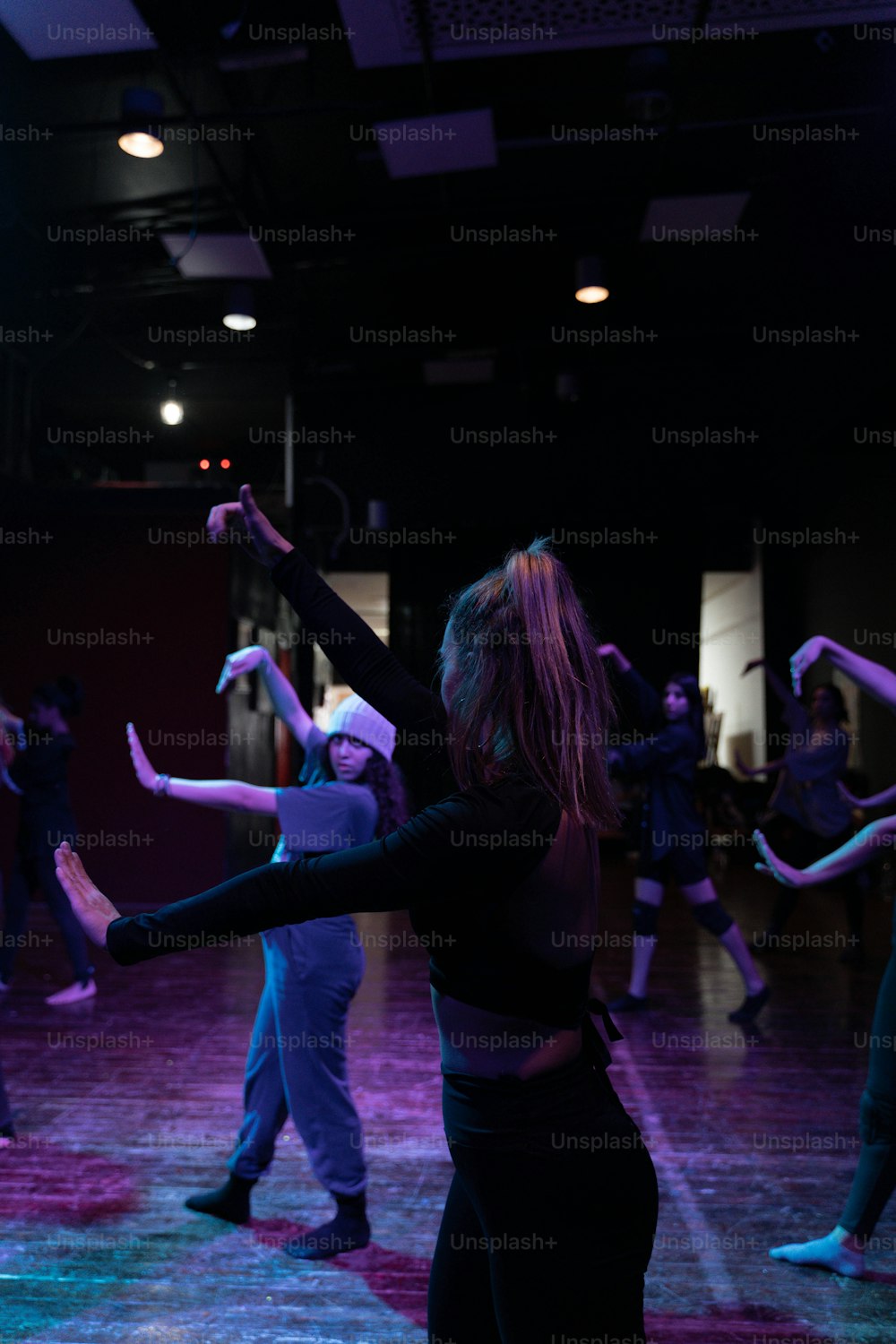 Un groupe de personnes dansant dans une pièce sombre