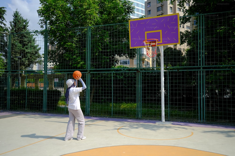 a man in a white shirt is playing basketball