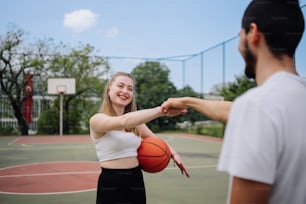 a woman holding a basketball on a basketball court