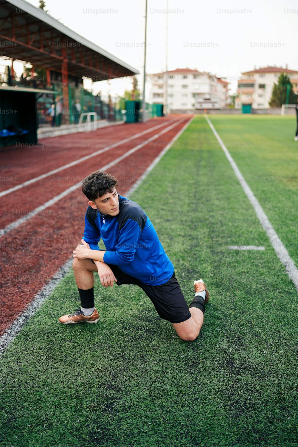 a man kneeling down on a soccer field