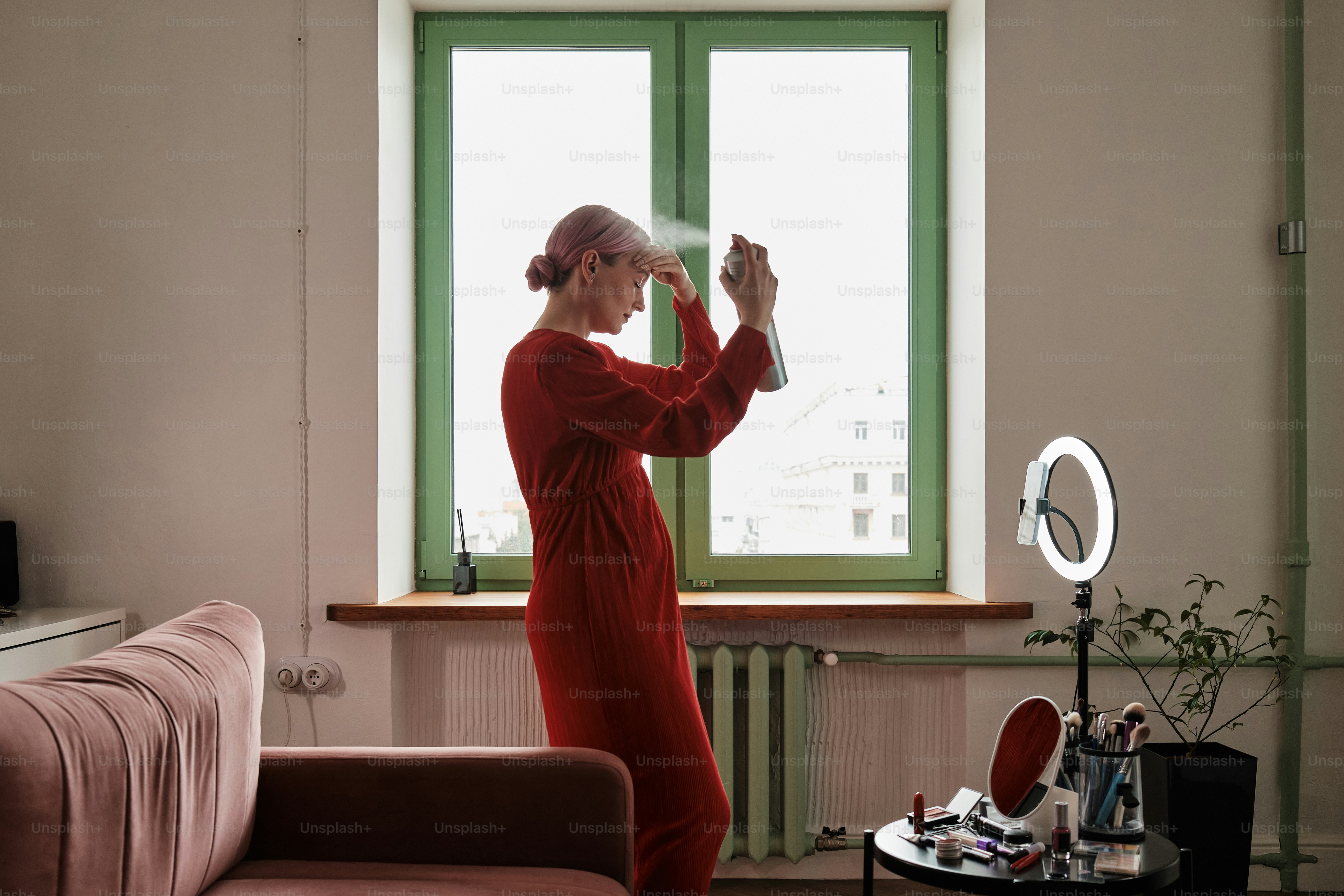 a woman in a red dress standing in front of a window