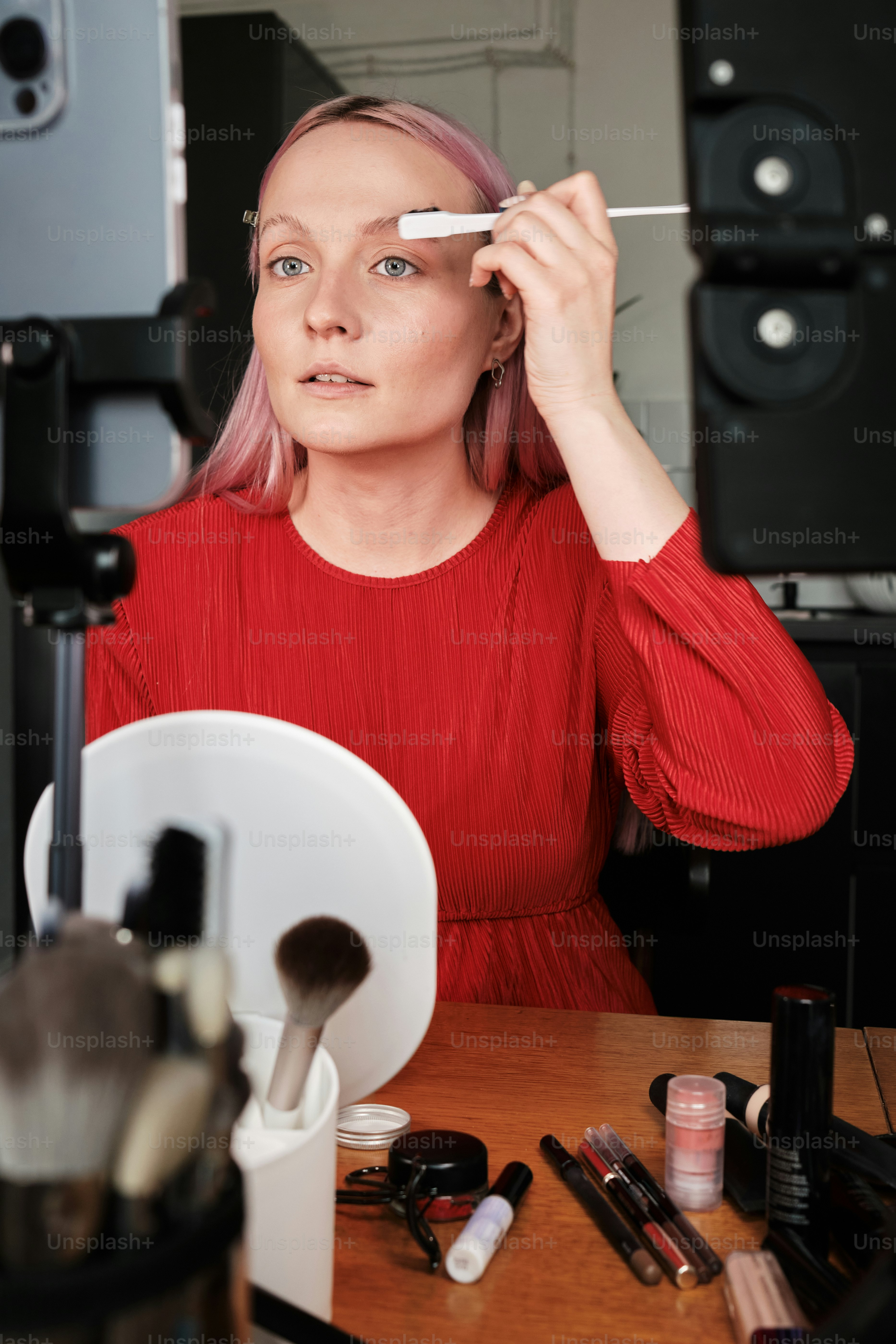 a woman in a red shirt is holding a brush
