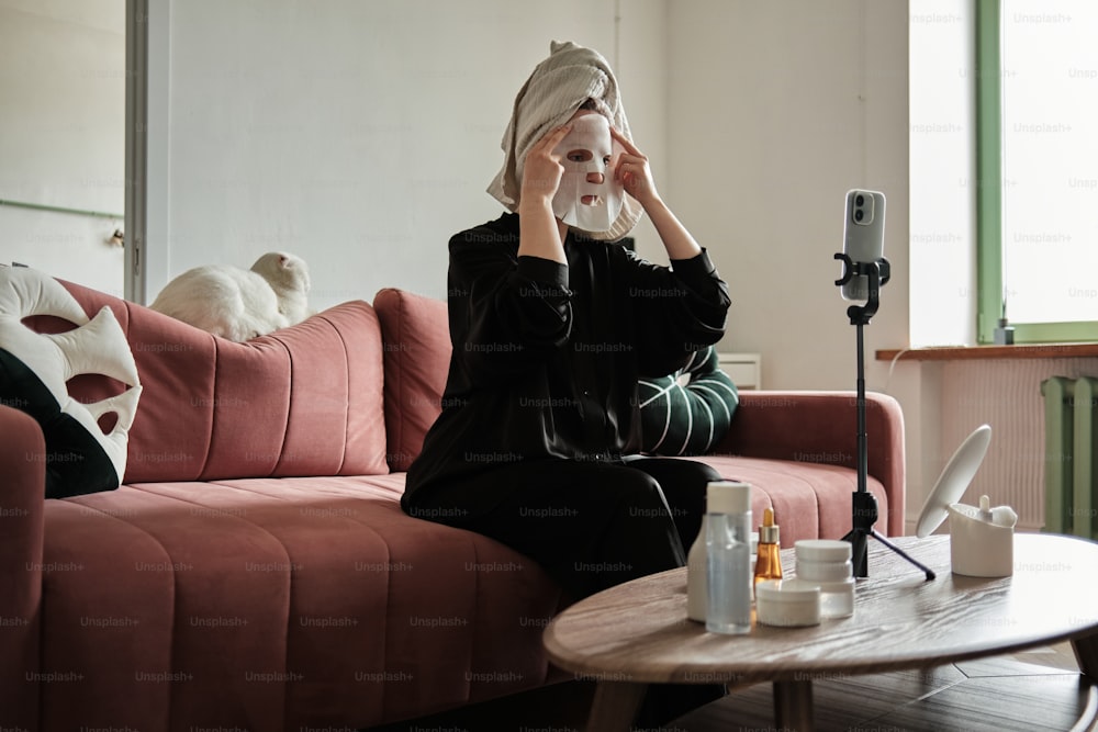 a woman sitting on top of a red couch