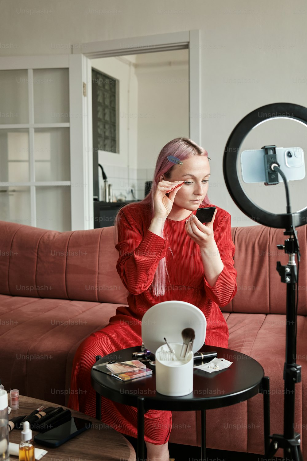 a woman sitting on a couch talking on a cell phone