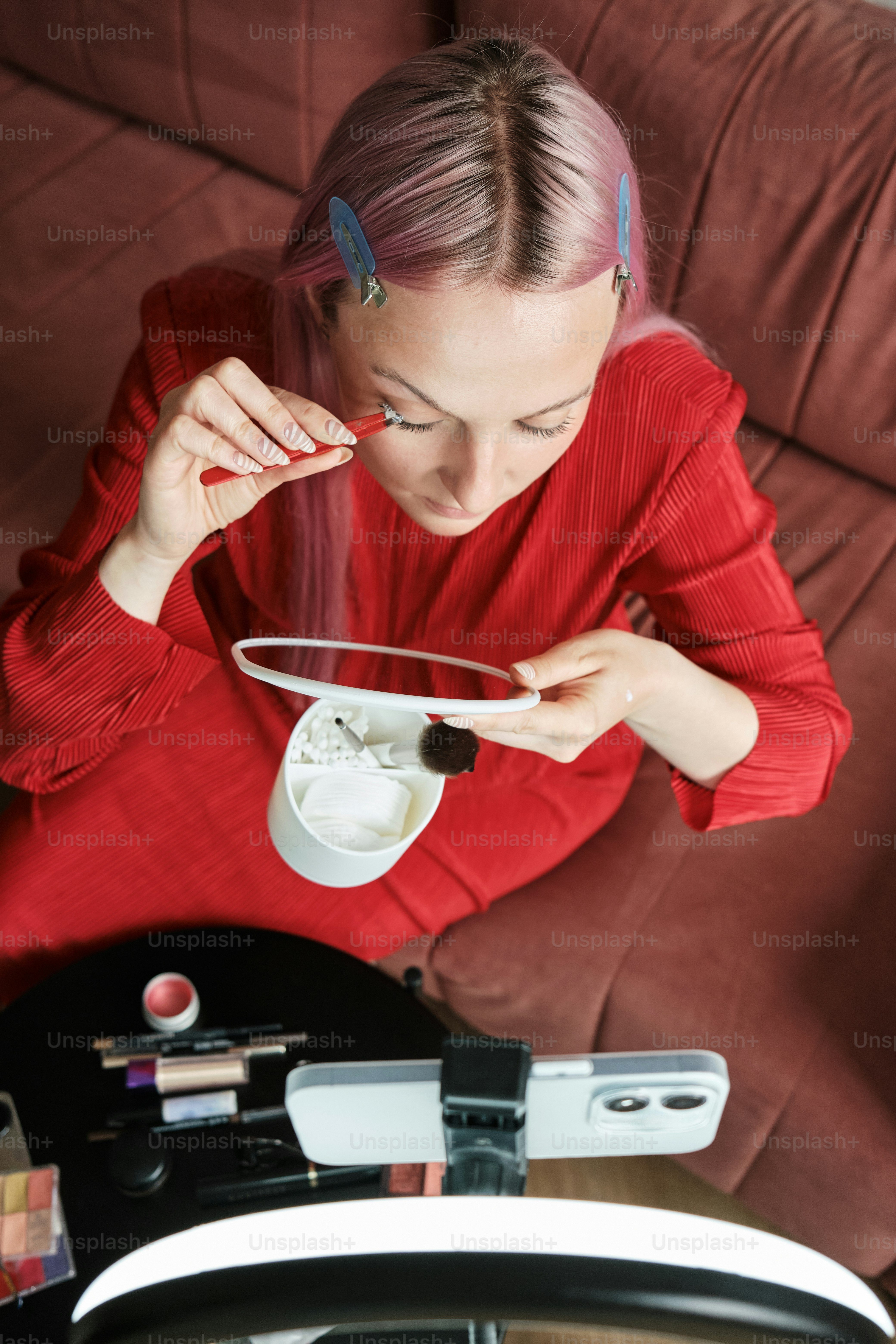 a woman sitting on a couch holding a plate